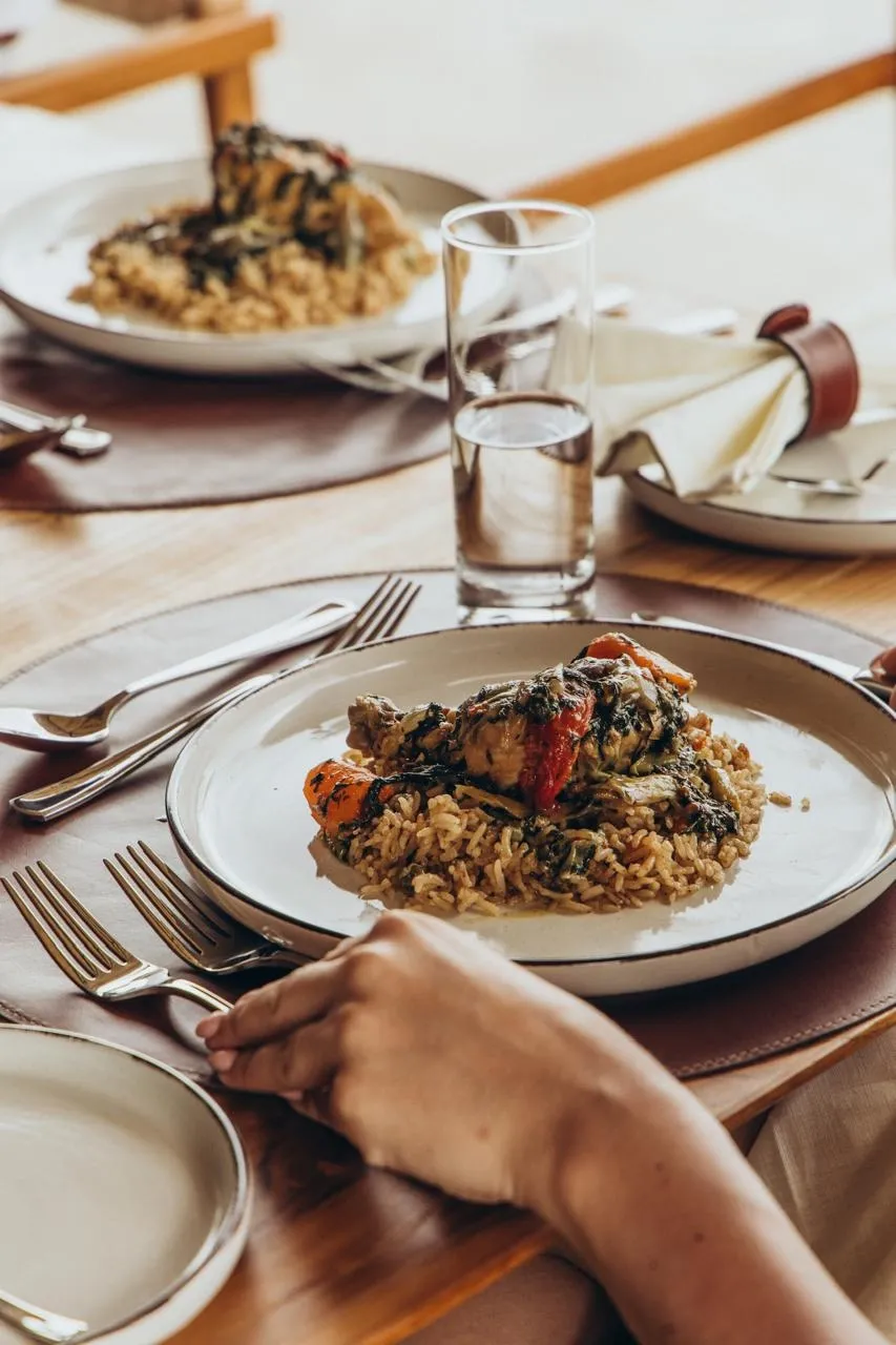 Plated gourmet meal of chicken, rice and vegetables served at a luxury safari camp, Tanzania